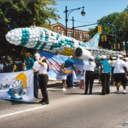 Parade with giant airplane balloon float