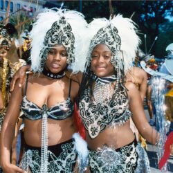 Two women in feathered carnival parade costumes