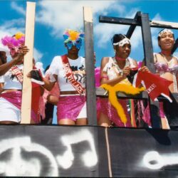 Women in colorful carnival costumes on float