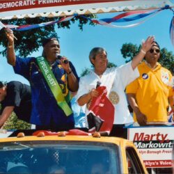 Three speakers at outdoor political campaign rally