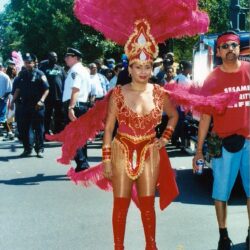Carnival performer in red feathered costume