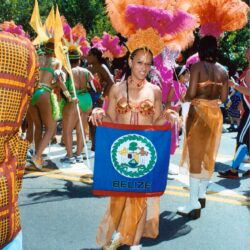 Carnival dancer holding Belize flag