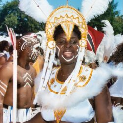 Smiling woman in white feathered carnival costume