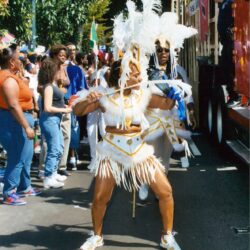 Carnival dancer wearing white feathered costume