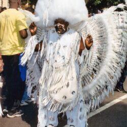 Performer in elaborate white feathered carnival costume
