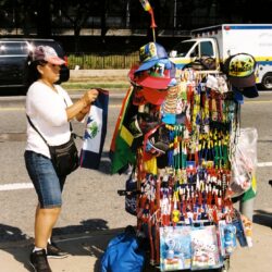 Street vendor selling colorful souvenirs and hats