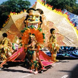 Colorful carnival dancer with giant sun float
