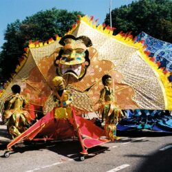 Colorful carnival float with giant theatrical mask
