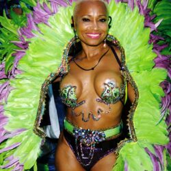Woman in green and purple feathered carnival costume