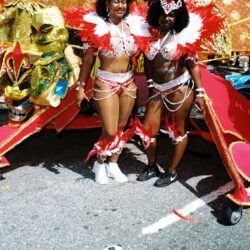 Two women in red feathered carnival costumes
