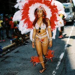Carnival dancer in red and white feathers