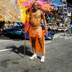 Carnival performer in orange feathered costume