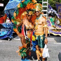 Couple in vibrant carnival costumes at parade