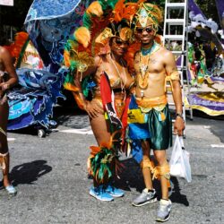 Two people in vibrant carnival costumes