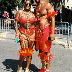 Couple in red carnival costumes at street festival