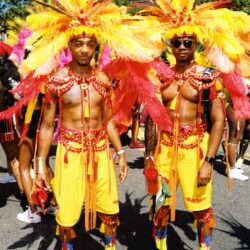 Two men in yellow and red carnival costumes