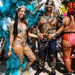 Couple in colorful feathered carnival costumes