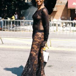 Woman in sheer black lace outfit smiling