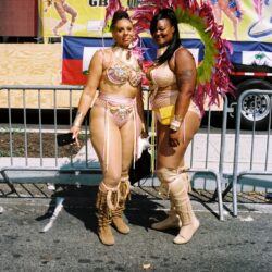 Two women in feathered carnival costumes