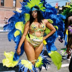 Carnival dancer in blue and green feathers
