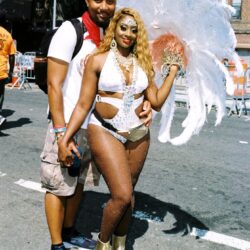 Couple at street carnival in feathered costume