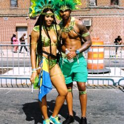 Couple in green feathered carnival costumes