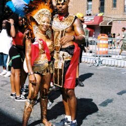 Couple wearing colorful carnival costumes on street