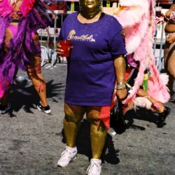 Person covered in gold paint at carnival