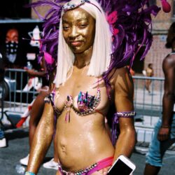 Carnival dancer in purple feathered costume