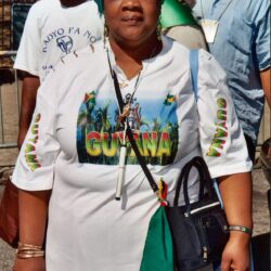 Person wearing Guyana shirt and headwrap
