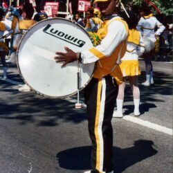 Marching band drummer in yellow uniform