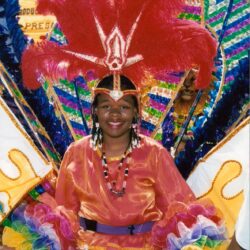 Smiling woman in vibrant feathered carnival costume