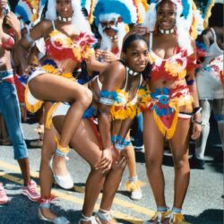 Women in colorful feathered carnival costumes