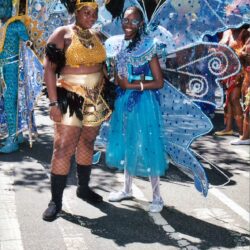 Two people in colorful carnival butterfly costumes