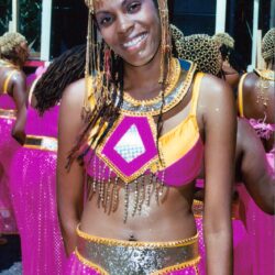 Smiling woman in pink and gold carnival costume