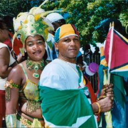 Couple in colorful carnival costumes holding flag