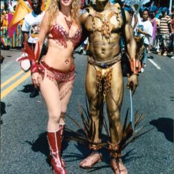 Carnival performers wearing red and gold costumes