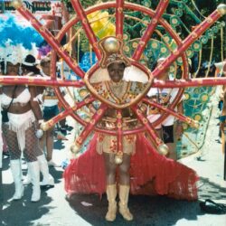 Person in ornate red-and-gold carnival costume