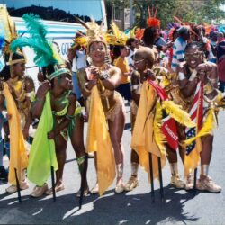 Carnival dancers in colorful feathered costumes