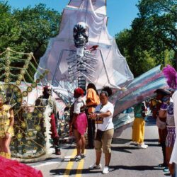 Giant skeleton float at colorful street parade