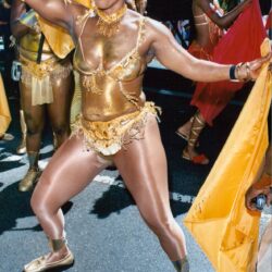 Woman in gold carnival costume dancing
