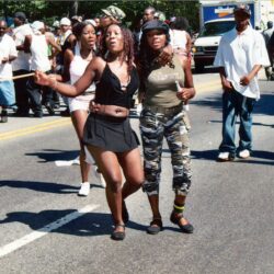 Two women dancing in street parade
