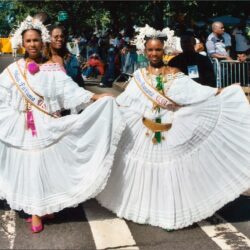 Two women in white pollera dresses at parade