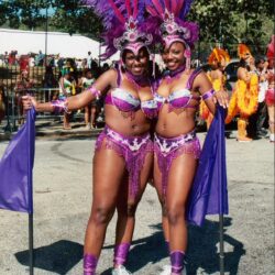 Two dancers in purple carnival costumes