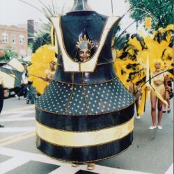 Black and gold parade costume with feathered dancers