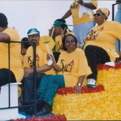 Group wearing yellow shirts on parade float
