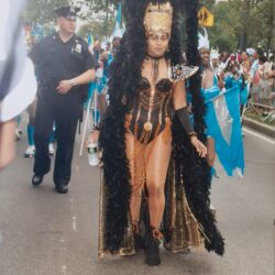 Woman in black feathered gold carnival costume