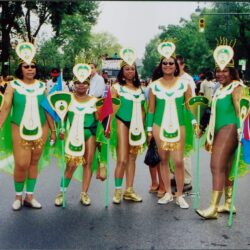 Six women in green carnival costumes