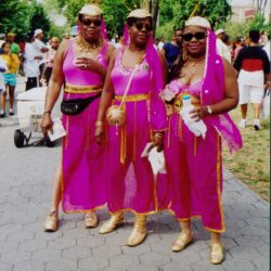Three women in pink parade carnival costumes