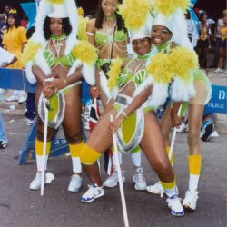 Carnival parade dancers in yellow-green costumes